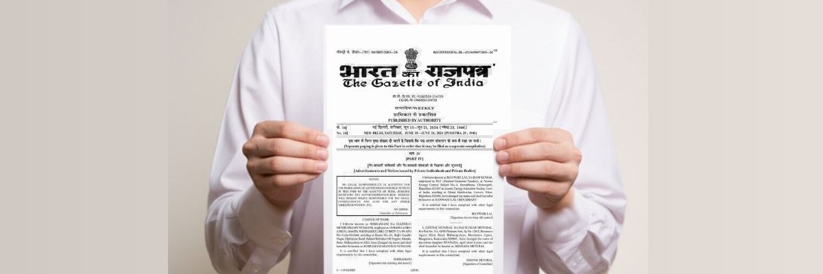 Presenting The Official Gazette of India Document Close-up of a person's hands holding up a copy of The Gazette of India (भारत का राजपत्र) document against a white background.